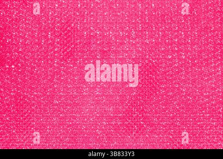 Solid pink background with a subtle, textured pattern of tiny, sparkling dots. Overall effect is bright and eye-catching, resembling a glitter Stock Photo
