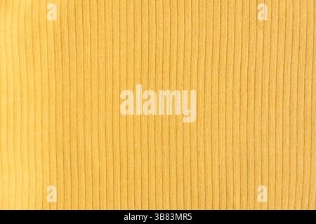 Ribbed cotton fabric texture yellow color . Close up rib cotton cloth and textiles pattern. Natural organic fabrics texture background. Stock Photo