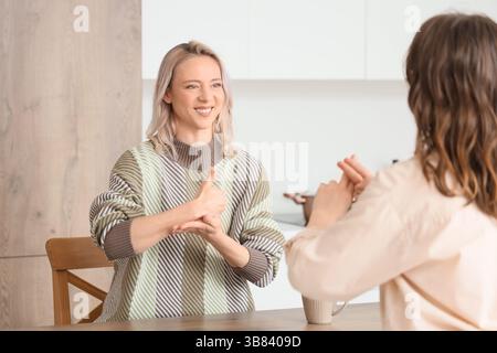 Women using sign language at home Stock Photo
