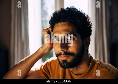 Close-up portrait of man with curly hair Stock Photo