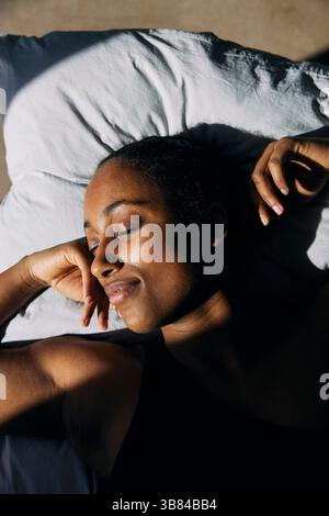 Directly above shot of woman sleeping on pillow at home Stock Photo