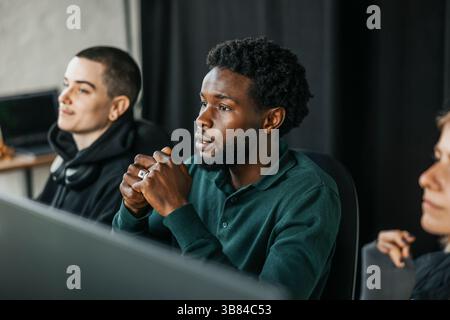 Focused businessman in meeting with colleague at tech startup company Stock Photo