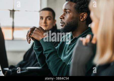 Focused male business professional in meeting with colleague at tech startup company Stock Photo