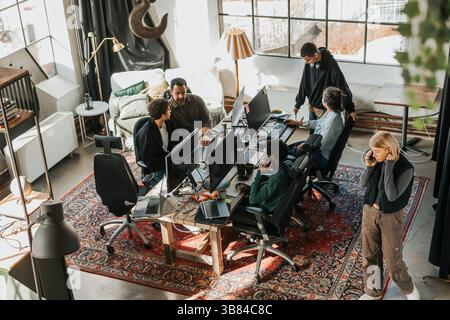 High angle view of computer programmers working in tech startup office Stock Photo