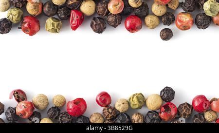 Mixed peppercorns background with white copy space in center. Food background with peppercorns. Different colored peppercorns pattern on white backgro Stock Photo