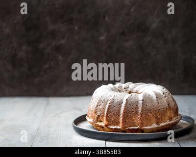 Fresh perfect muffin cake decorated icing sugar over table. Copy space for text. Ideas and recipes for breakfast or dessert Stock Photo