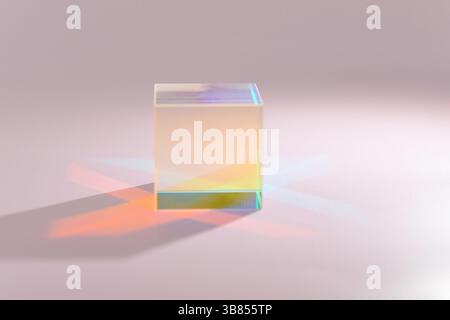 A clear prism refracts light, creating a vibrant display of gradient colors on a light pink surface, showcasing light properties Stock Photo