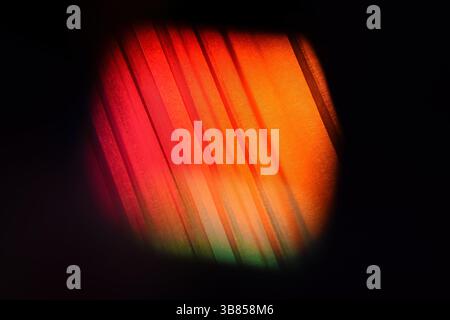 Abstract light through a textured prism surface, creating a captivating spectrum of colors. Backgrounds and backdrops Stock Photo