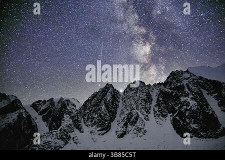 Milky Way and snowy mountains in Altai at night Stock Photo