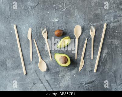 Avocado Seeds Biodegradable Single-Use Cutlery. Bioplastic - Great alternative to plastic disposable cutlery. Top view, flat lay. Gray background Stock Photo