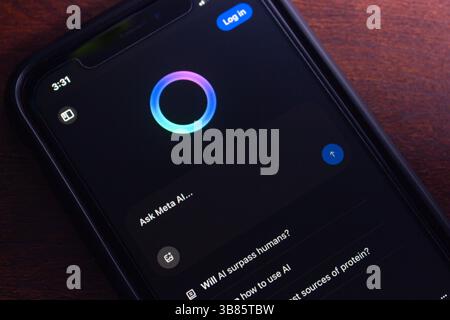 Smartphone screen showing the Meta AI chat interface with a prompt input field and suggested AI-generated questions, in dark mode. Stock Photo