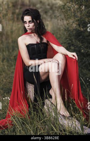 Evil witch woman sitting outdoors Stock Photo
