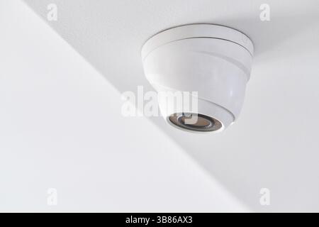 Cctv on white ceiling in modern building Stock Photo