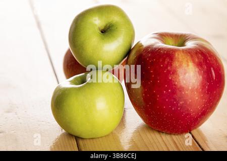 Red and green apples on the wood table Stock Photo