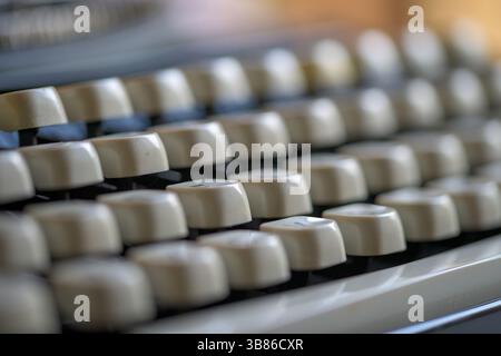 Close-up of cream-coloured keys on a vintage typewriter, with shallow depth of field – conceptual image for writing, nostalgia, or retro technology Stock Photo