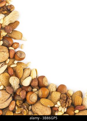 Background of mixed nuts - hazelnuts, almonds, walnuts, pistachios, peanuts, pine nuts peeled and not peeled - vertical with copy space. Isolated one Stock Photo