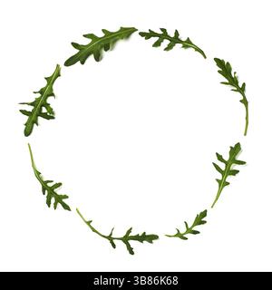 Pattern from arugula in round circle frame isolated. Circle shape in fresh green ruccola or arugula. Isolated on white with clipping path. Top view or Stock Photo