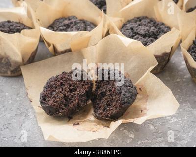 Gluten-free vegan chocolate muffins with beetroot, almond powder, buckwheat flour and karob or cocoa . Homemade cupcakes on gray concrete background w Stock Photo