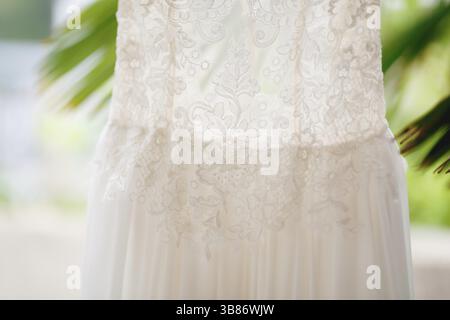 Close-up of the texture of the pattern of the bride's dress at the waist of the dress. Stock Photo