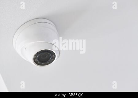 Cctv on white ceiling in modern building Stock Photo