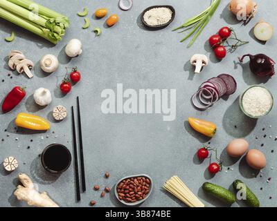 Asian food ingredients with copy space. Various of Chinese cooking ingredients and chopsticks on gray stone background. Asian food concept. Copy space Stock Photo