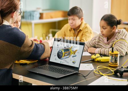 Students participating in interactive science lesson with a teacher guiding them. Educational tools and technology are used to enhance learning experi Stock Photo