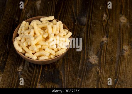corn sticks close up, a large number of corn sticks for eating or making breakfast with milk, corn sticks in a wooden bowl Stock Photo