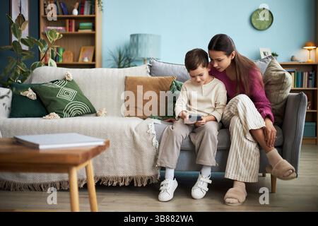 Boy Playing Game On Mobile Phone Stock Photo