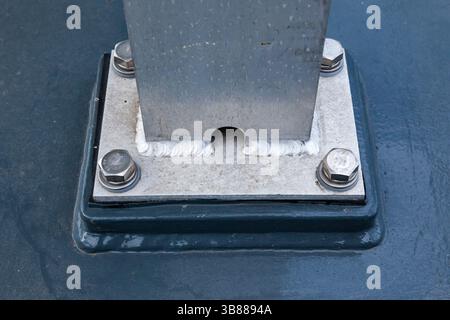 A welded aluminum post welded to the plate and bolted to the deck, close-up. Stock Photo