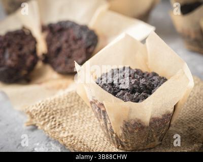 Gluten-free vegan chocolate muffins with beetroot, almond powder, buckwheat flour and karob or cocoa . Homemade cupcakes on gray concrete background w Stock Photo