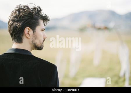 Young man in a black jacket. Back view. Portrait. Stock Photo