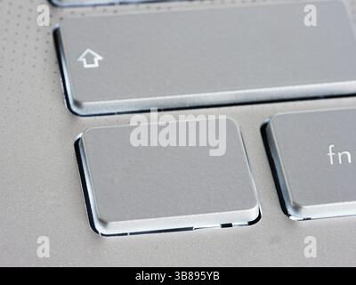 Blank silver button on laptop keyboard. Empty key button with copy space for message. Extreme close up Stock Photo