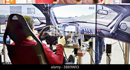 Gamer playing on computer simulator race of car Stock Photo