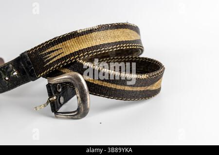 Black leather and fabric belt with silver buckle and tribal motif. Stylish and functional men's accessory for casual wear Stock Photo