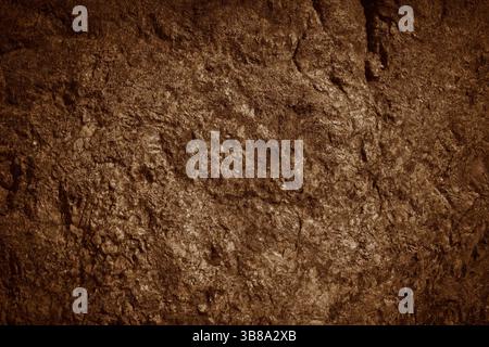 Brown rocky surface texture. Brown natural stone mountain background. Stock Photo