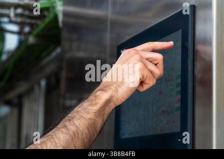 Factory worker using control panel on production line Stock Photo