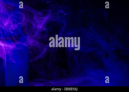 Dark background with purple blue smoke trails Stock Photo