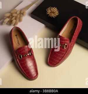 Men's Red Crocodile Textured Leather Loafers with Gold Buckle Stock Photo