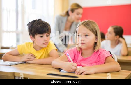 Kid cheating during test Stock Photo