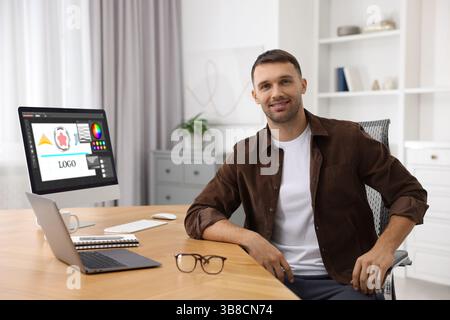Designer working on different computers at table in office Stock Photo