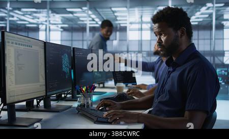 Developers in data center workspace implementing AI predictive maintenance systems. Admin in server hub office using artificial intelligence machine learning tech to identify hardware failures Stock Photo