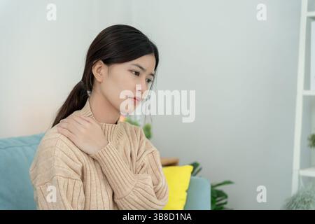 office syndromes, woman massaging neck pain due to work and using a computer, digital composite of a focused spine of neck pain and shoulder pain symp Stock Photo