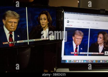 October 24, 2007, New York City, New York, U.S: Former President Donald Trump debates Vice President Kamala Harris during their first Presidential debate in Philadelpia, Pennsylvania..Debate being watched on devices Apple Iphone and Apple MacBook Pro. (Credit Image: © Billy Tompkins/ZUMA Press Wire) Stock Photo