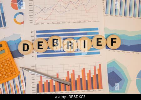 Debrief - word concept on building blocks, text, letters. Stock Photo