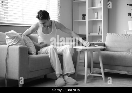 Young man with anorexia refusing from bun at home Stock Photo