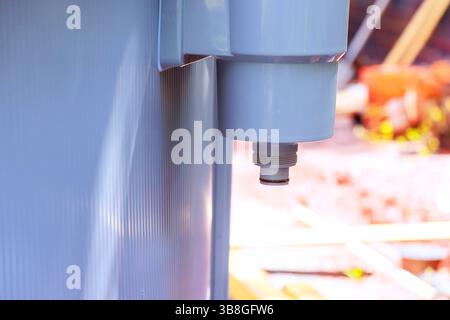 Plumber is installing pool filter system, checking connections gauges in backyard environment. Stock Photo