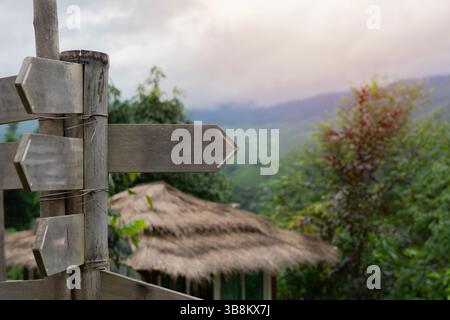 Wooden track pointer on the resort of hight mountain in sunny summer day. Copy space. Sign concept. Stock Photo