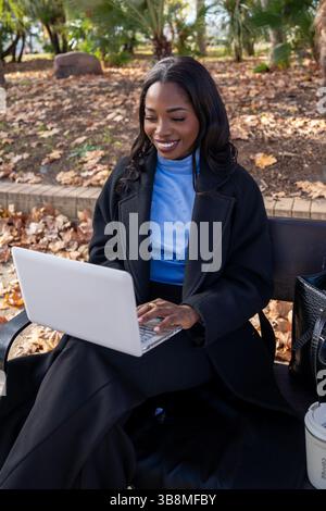 Young manager enjoying working outdoors on a beautiful autumn day Stock Photo