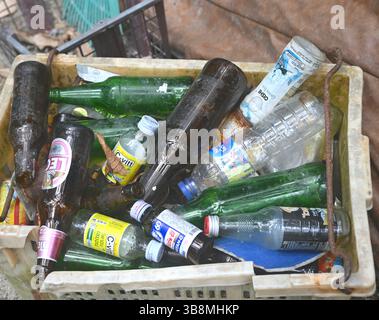 Glass and plastic bottles in a crate. Stock Photo