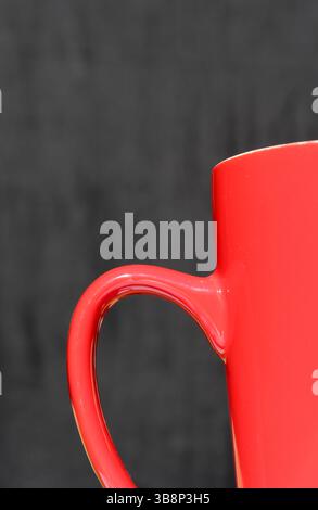Close up of a red mug against a dark background abstract Stock Photo